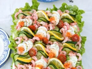 Smörgåstårte - a smorgåsbord in a sort of sandwich cake. Salmon, prawns, boiled egg, mayonnaise, creme fraiche, cherry tomatoes, cucumber — everything that Swedes love to celebrate their special occasions.
