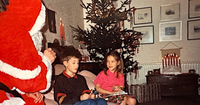 Tomten sitting in our house in Wales; Edwin and Josie shy on the sofa in front of him. Probably 1991.
