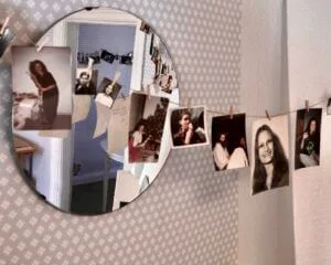 The photo display - dozens of photos of Lena hung on a line with pegs, some of them reflected from the other side of the room in a mirror
