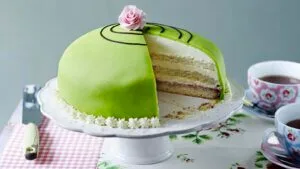 Prinsesstårte or Princess cake - a Swedish cake for those very special occasions. A sponge cake in several layers with a custard and jam filling, and lashings of cream. But the main characteristic is its outer coating of sweet marzipan tinted green