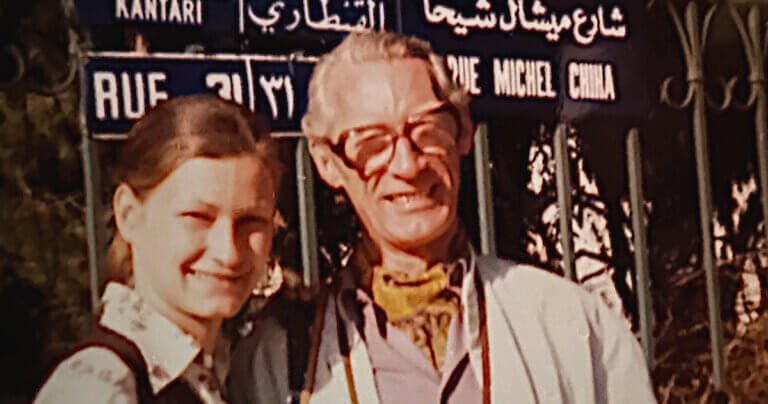 Lena pictured smiling with father Gunnar, standing next to a street-sign in Beirut 1973