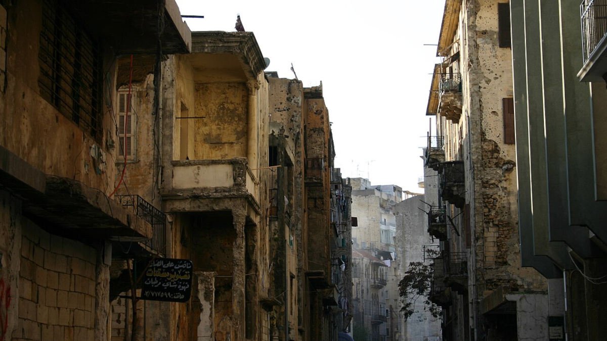 War-damaged buildings in a narrow Beirut street