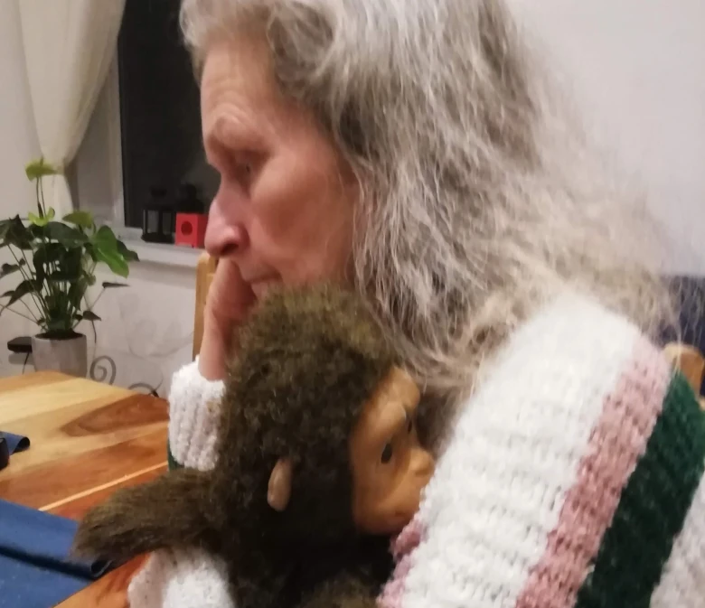 Lena hugging a monkey (puppet)